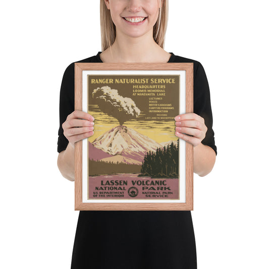 Person holding a framed poster of Lassen Volcanic National Park with a mountain and forest design.