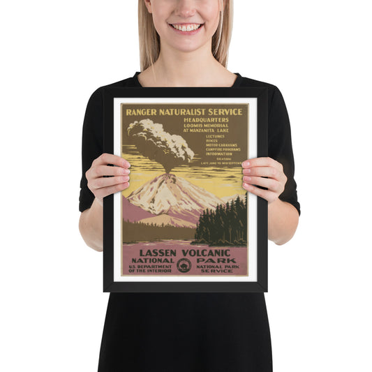 Person holding a framed poster of Lassen Volcanic National Park with a mountain and forest design.
