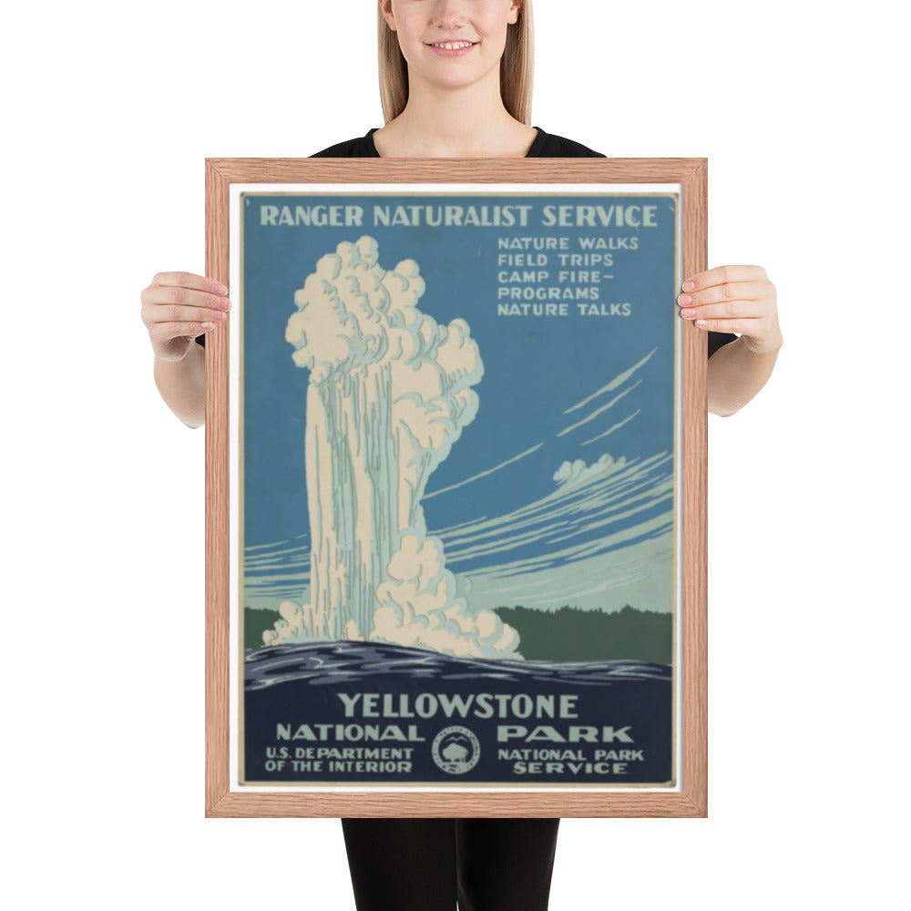 Person holding a framed Yellowstone National Park poster with a waterfall illustration.