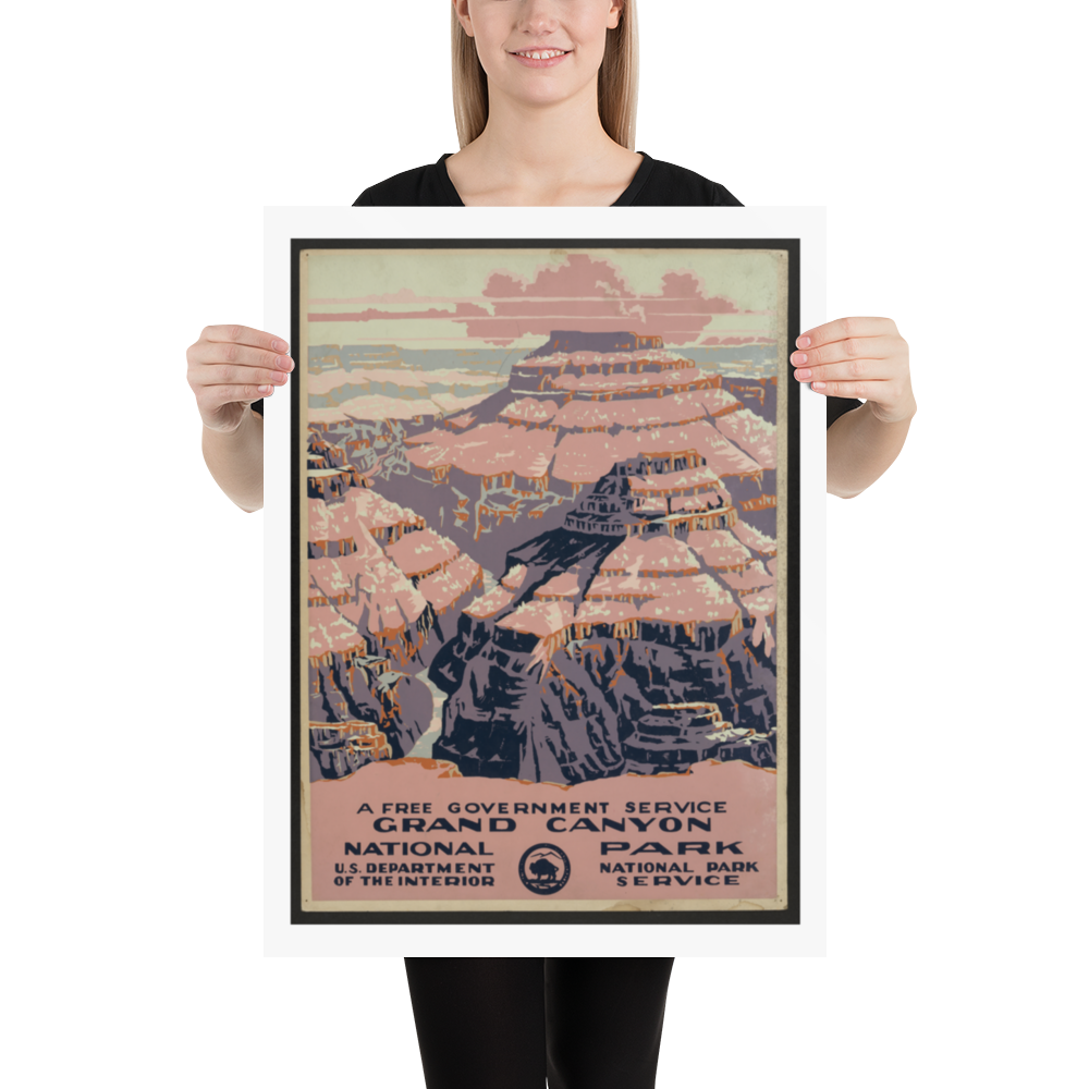 Person holding a framed poster of the Grand Canyon National Park.