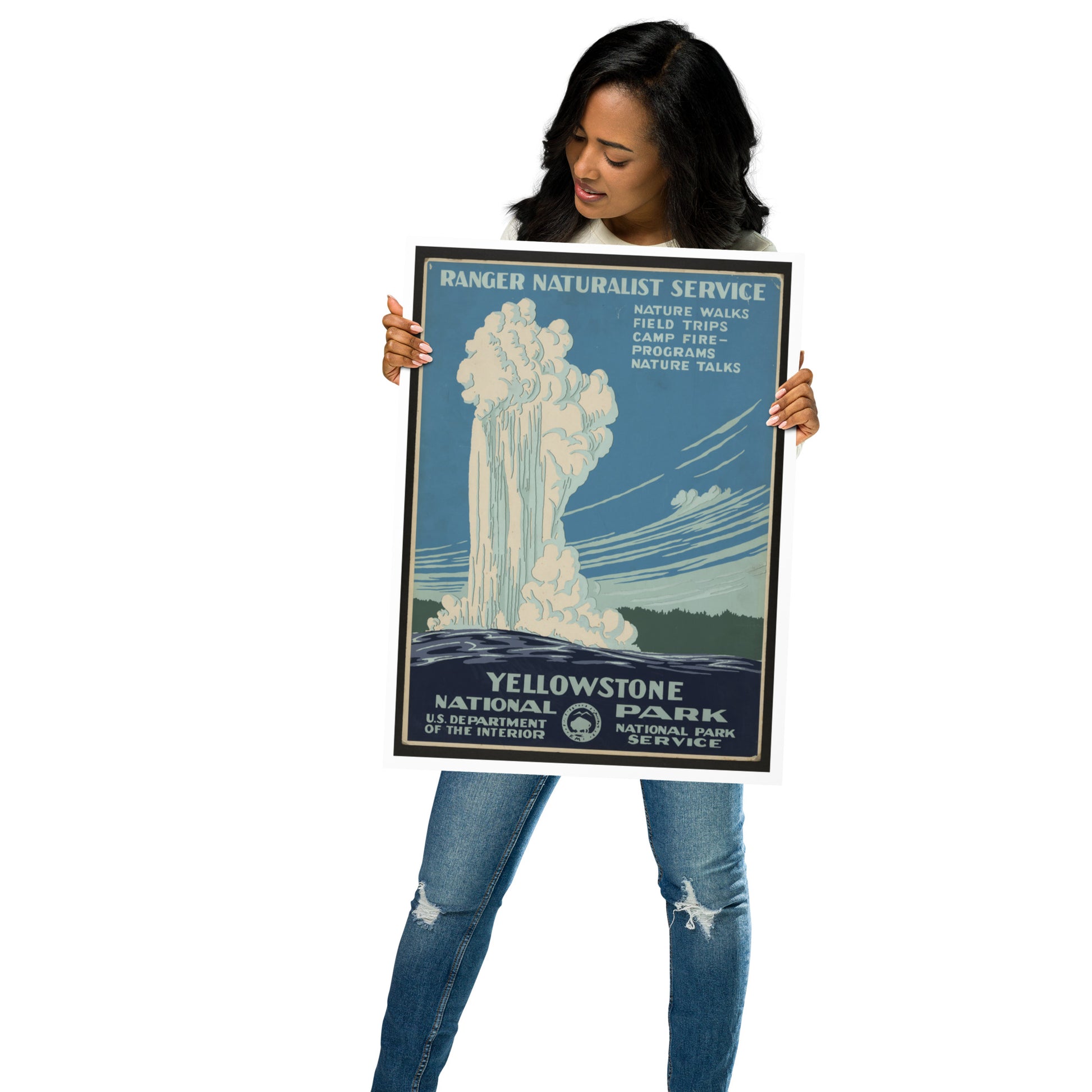 Person holding a Yellowstone National Park poster with a scenic design.